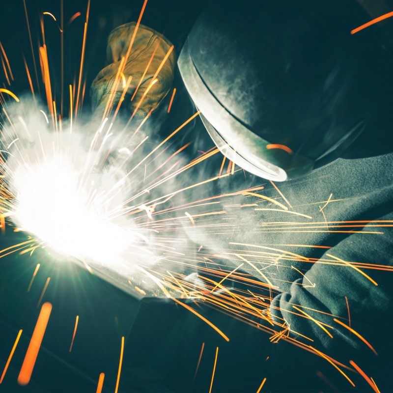Welder is Welding Two Metal Parts Together